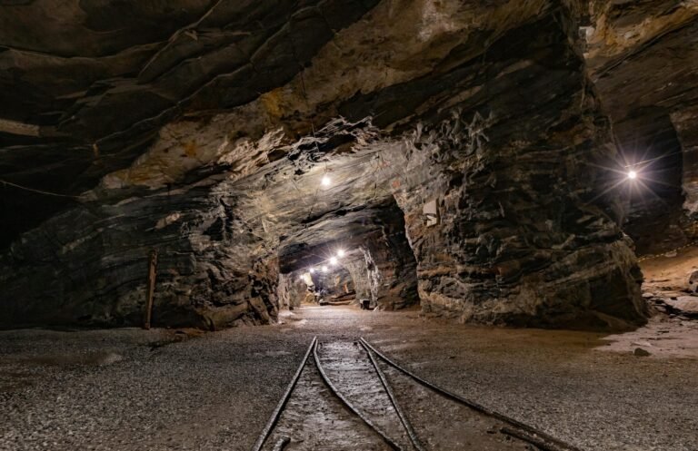 Underground mining truck with FOG-based inertial navigation system maintaining sub-degree accuracy in high-vibration mining environments, preventing collisions in narrow tunnels.