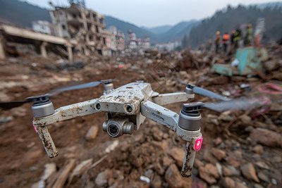 Search and rescue drone with laser rangefinder and AI thermal imaging scanning earthquake rubble for survivors